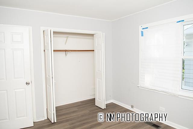 9828 Warren Ave, Oak Lawn, IL 60453 - unfurnished bedroom with wood finished floors and a closet