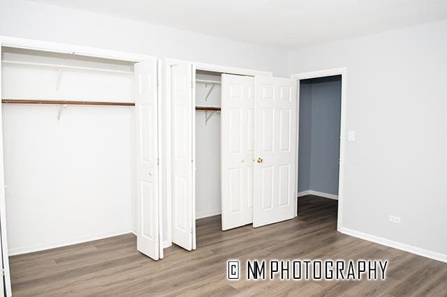 9828 Warren Ave, Oak Lawn, IL 60453 - unfurnished bedroom with wood finished floors and multiple closets
