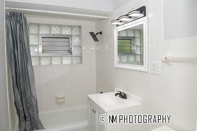 9828 Warren Ave, Oak Lawn, IL 60453 - full bathroom featuring shower / bathtub combination with curtain, vanity, and tile walls