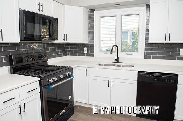 9828 Warren Ave, Oak Lawn, IL 60453 - kitchen featuring black appliances, white cabinets, and light countertops