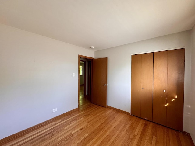 15542 S Park Ave, South Holland, IL 60473 - unfurnished bedroom with light wood-style flooring and a closet
