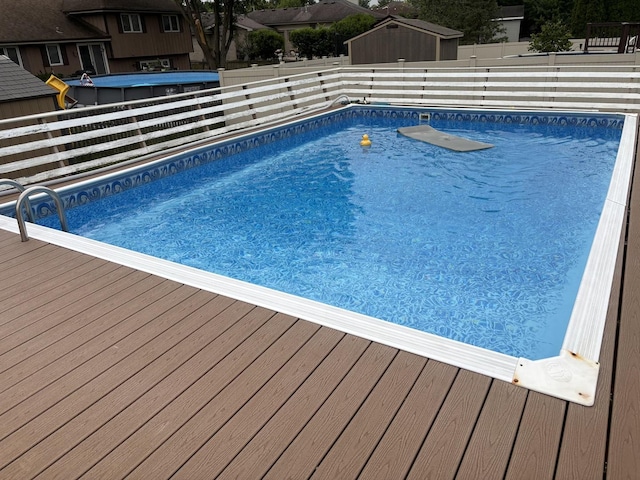 16529 Edgewood Dr, Plainfield, IL 60586 - view of swimming pool featuring a fenced backyard, a wooden deck, and a shed