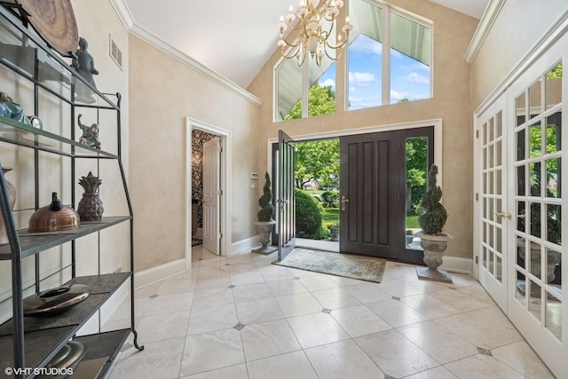 1881 Haven Ln, Green Oaks, IL 60048 - foyer entrance with high vaulted ceiling, a chandelier, french doors, tile patterned flooring, and ornamental molding