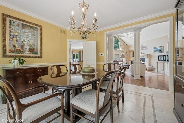1881 Haven Ln, Green Oaks, IL 60048 - dining space featuring ornate columns, a chandelier, inlaid floor details, ornamental molding, and light tile patterned floors
