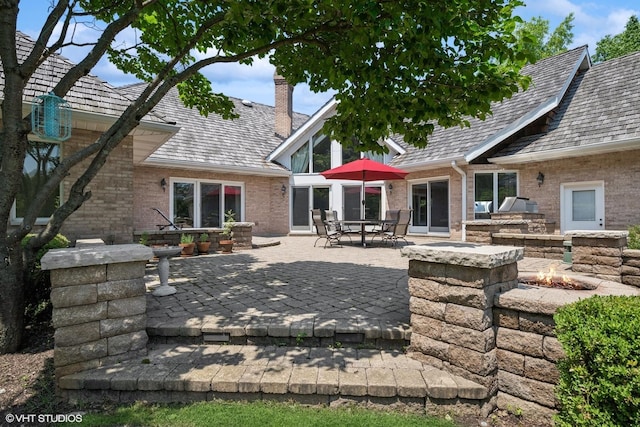 1881 Haven Ln, Green Oaks, IL 60048 - rear view of property featuring brick siding, a chimney, a patio, and an outdoor fire pit