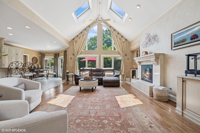 1881 Haven Ln, Green Oaks, IL 60048 - living room with a skylight, high vaulted ceiling, wood-type flooring, a high end fireplace, and ceiling fan