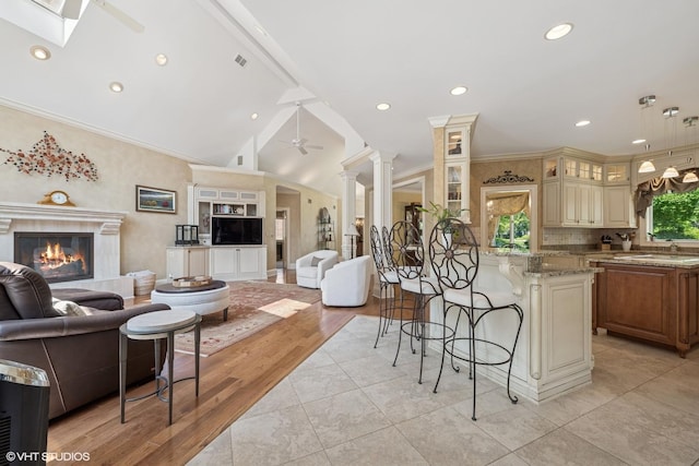 1881 Haven Ln, Green Oaks, IL 60048 - living area featuring a premium fireplace, vaulted ceiling, a ceiling fan, a skylight, and recessed lighting