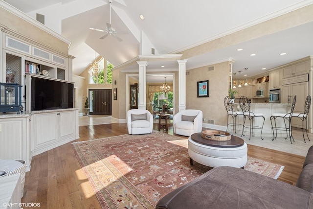 1881 Haven Ln, Green Oaks, IL 60048 - living area with decorative columns, ceiling fan, a chandelier, light wood finished floors, and high vaulted ceiling