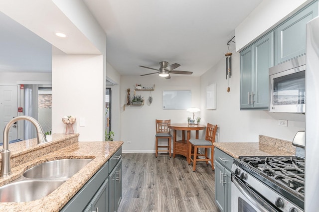 8306 Portsmouth Dr Unit 22B, Darien, IL 60561 - kitchen featuring appliances with stainless steel finishes, light wood-style flooring, a ceiling fan, light stone counters, and recessed lighting