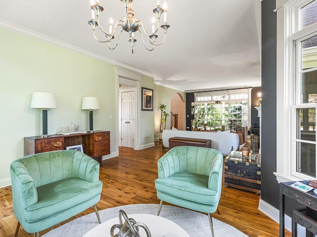 2207 N Elmkirk Pkwy N, Mchenry, IL 60051 - living room featuring a chandelier, ornamental molding, wood finished floors, and arched walkways
