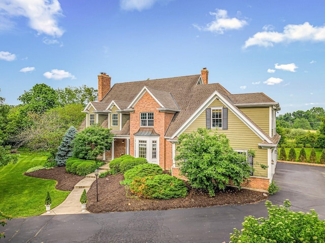 2207 N Elmkirk Pkwy N, Mchenry, IL 60051 - traditional home with brick siding and a chimney