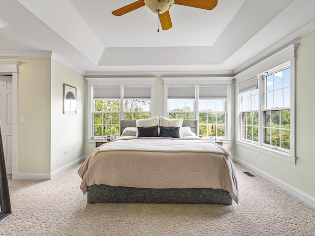 2207 N Elmkirk Pkwy N, Mchenry, IL 60051 - bedroom featuring a tray ceiling, carpet, multiple windows, a ceiling fan, and crown molding