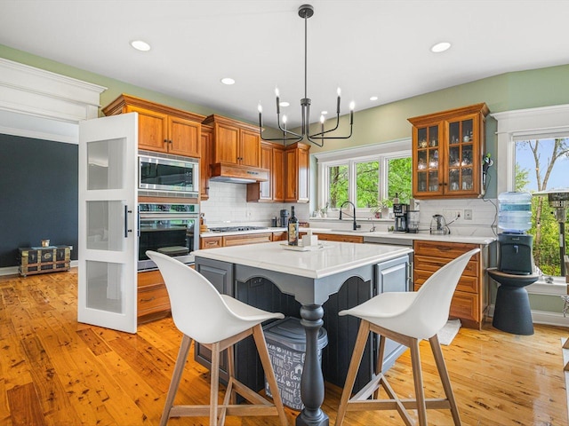 2207 N Elmkirk Pkwy N, Mchenry, IL 60051 - kitchen featuring appliances with stainless steel finishes, brown cabinets, backsplash, light countertops, and recessed lighting