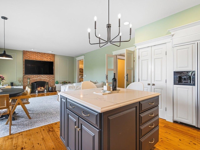 2207 N Elmkirk Pkwy N, Mchenry, IL 60051 - kitchen featuring light wood-style floors, a center island, a chandelier, and hanging light fixtures