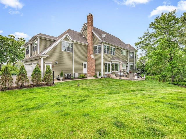 2207 N Elmkirk Pkwy N, Mchenry, IL 60051 - rear view of property featuring entry steps, an attached garage, a lawn, and a patio