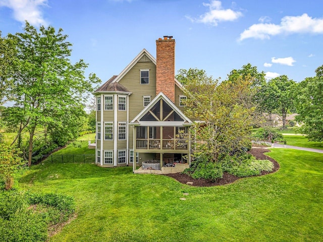 2207 N Elmkirk Pkwy N, Mchenry, IL 60051 - rear view of house with a chimney and a sunroom