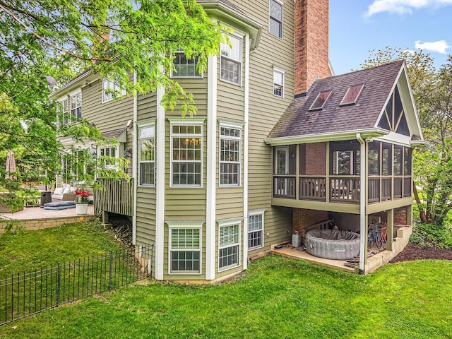 2207 N Elmkirk Pkwy N, Mchenry, IL 60051 - back of house with a sunroom, a chimney, roof with shingles, and a patio area