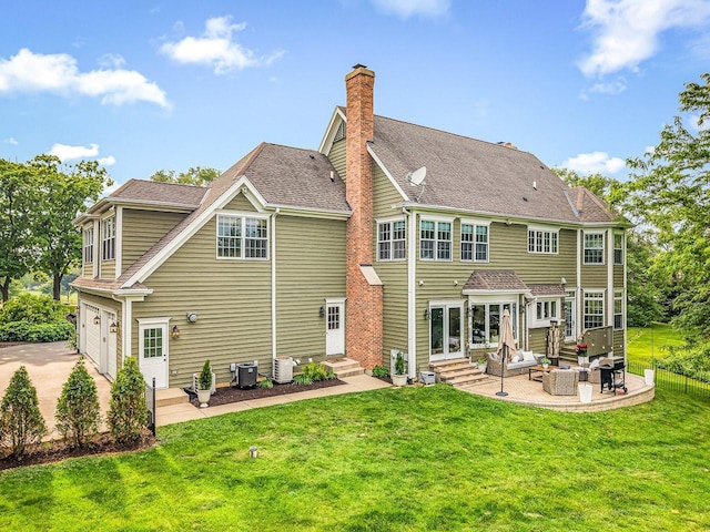 2207 N Elmkirk Pkwy N, Mchenry, IL 60051 - rear view of property featuring entry steps, an attached garage, a chimney, a patio area, and an outdoor hangout area