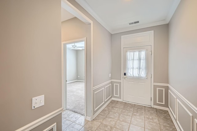 13490 Honeysuckle Dr, Huntley, IL 60142 - doorway to outside featuring a decorative wall, wainscoting, light tile patterned floors, crown molding, and a ceiling fan