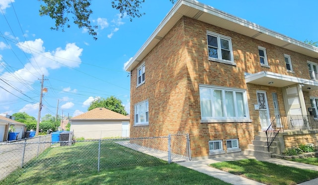 5448 N Washtenaw Ave, Chicago, IL 60625 - view of property exterior featuring brick siding and a gate
