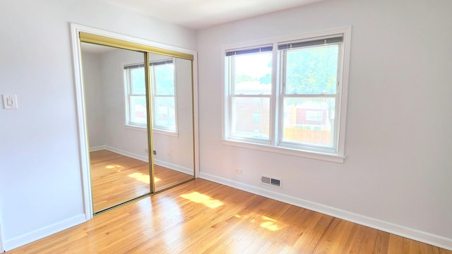 5448 N Washtenaw Ave, Chicago, IL 60625 - unfurnished bedroom featuring light wood finished floors and a closet