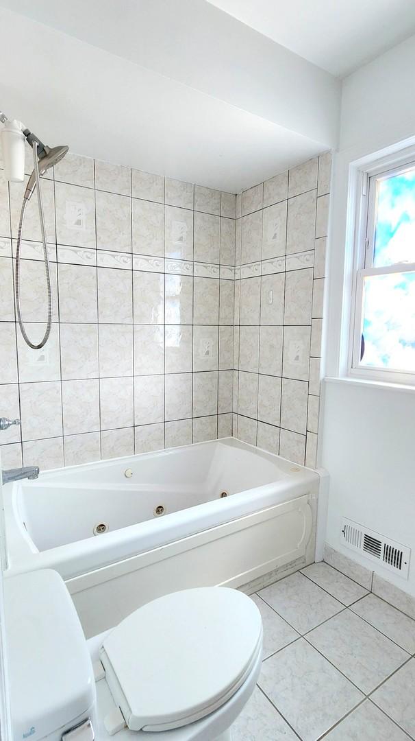5448 N Washtenaw Ave, Chicago, IL 60625 - full bath with tile patterned flooring and a combined bath / shower with jetted tub