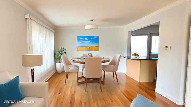 5448 N Washtenaw Ave, Chicago, IL 60625 - dining area featuring light wood-style floors and ornamental molding