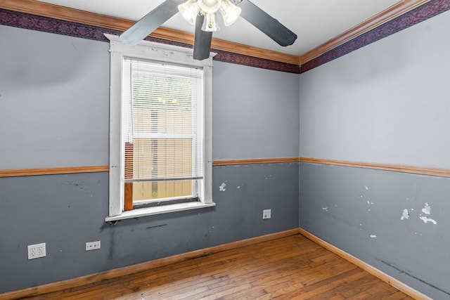 5212 S Honore St, Chicago, IL 60609 - empty room featuring a ceiling fan, hardwood / wood-style flooring, and ornamental molding