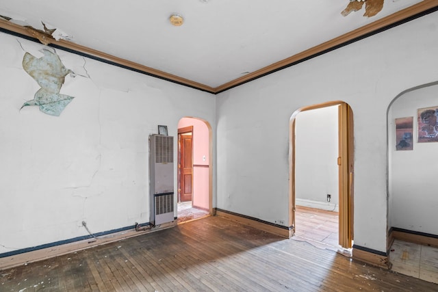 5212 S Honore St, Chicago, IL 60609 - spare room with arched walkways, a heating unit, hardwood / wood-style floors, ornamental molding, and a smoke detector