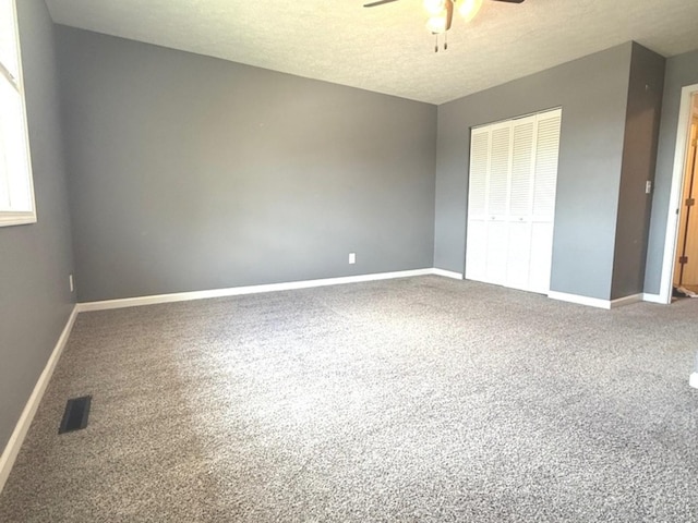 1508 Hancock Dr Unit 1, Normal, IL 61761 - unfurnished bedroom with carpet floors, a closet, a textured ceiling, and ceiling fan