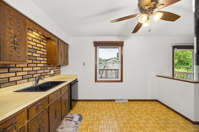 2110 Sanford Ave, New Lenox, IL 60451 - kitchen featuring a ceiling fan, dishwashing machine, light countertops, brick patterned floors, and backsplash