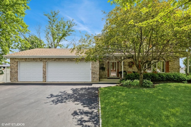 920 Barnside Rd, New Lenox, IL 60451 - view of front of home featuring asphalt driveway, brick siding, a front yard, and a garage
