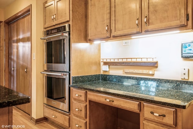 920 Barnside Rd, New Lenox, IL 60451 - kitchen featuring stainless steel double oven, light wood-style floors, dark stone countertops, and brown cabinetry