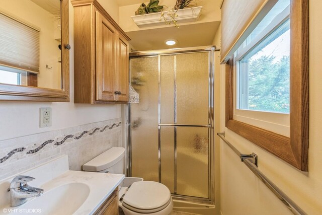920 Barnside Rd, New Lenox, IL 60451 - bathroom featuring a shower stall, vanity, and tile walls