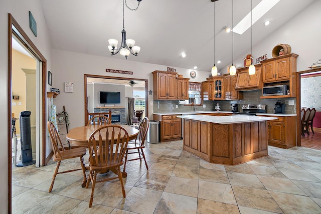 4751 N 5500w Rd, Kankakee, IL 60901 - kitchen featuring stainless steel appliances, brown cabinets, light countertops, backsplash, and recessed lighting