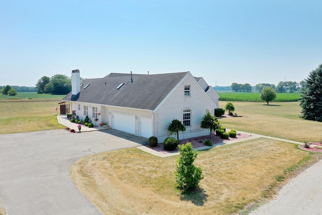 4751 N 5500w Rd, Kankakee, IL 60901 - view of property exterior with an attached garage, a chimney, driveway, and a lawn