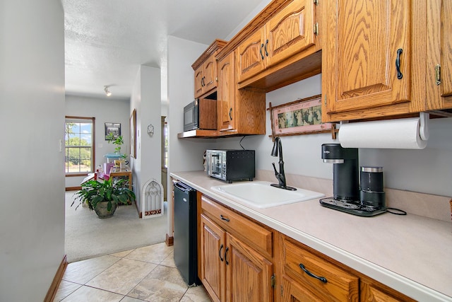 4751 N 5500w Rd, Kankakee, IL 60901 - kitchen featuring light countertops, light carpet, brown cabinetry, light tile patterned floors, and black microwave