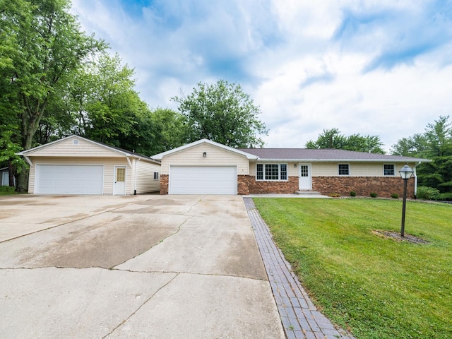 14746 Mercury Ln, Bloomington, IL 61705 - single story home with a front yard, brick siding, and a detached garage