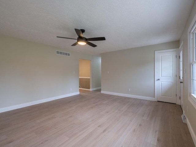 14746 Mercury Ln, Bloomington, IL 61705 - empty room featuring a ceiling fan, light wood finished floors, and a textured ceiling