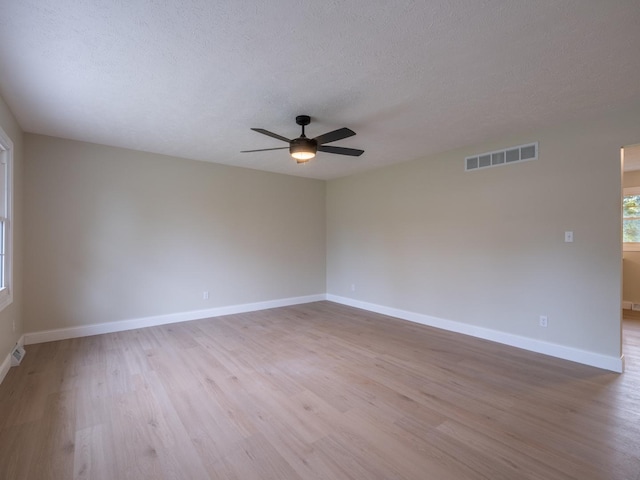 14746 Mercury Ln, Bloomington, IL 61705 - unfurnished room featuring a ceiling fan, light wood-type flooring, and a textured ceiling