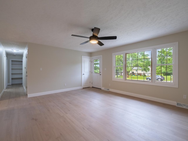 14746 Mercury Ln, Bloomington, IL 61705 - unfurnished room featuring a textured ceiling, light wood finished floors, and ceiling fan