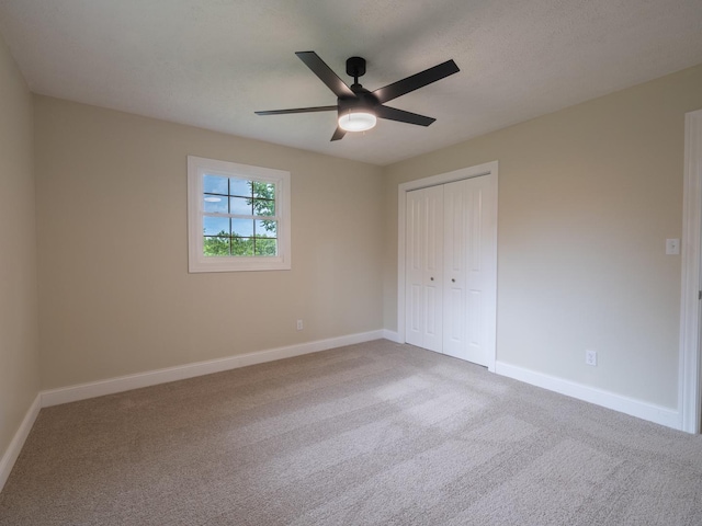 14746 Mercury Ln, Bloomington, IL 61705 - unfurnished bedroom featuring carpet flooring, a closet, and ceiling fan