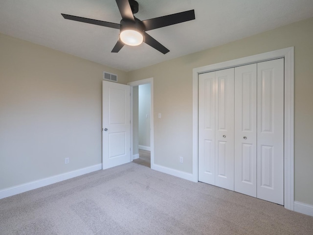 14746 Mercury Ln, Bloomington, IL 61705 - unfurnished bedroom with carpet, a closet, and ceiling fan