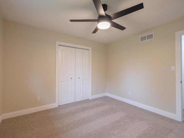 14746 Mercury Ln, Bloomington, IL 61705 - unfurnished bedroom featuring carpet floors, a closet, and a ceiling fan