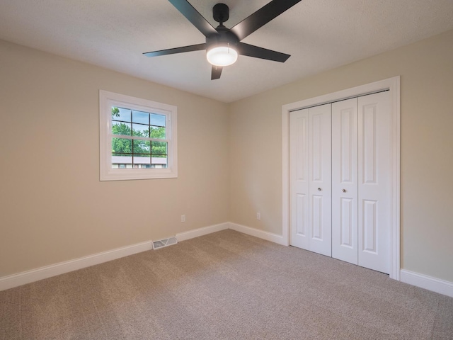 14746 Mercury Ln, Bloomington, IL 61705 - unfurnished bedroom with carpet flooring, a closet, and a ceiling fan