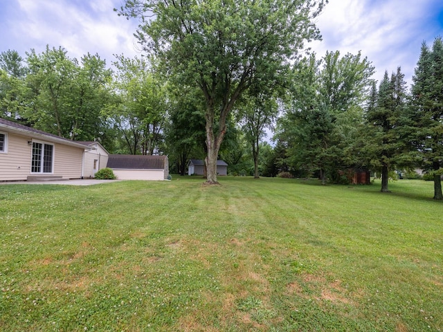14746 Mercury Ln, Bloomington, IL 61705 - view of green lawn featuring a patio area, an outdoor structure, and view of scattered trees