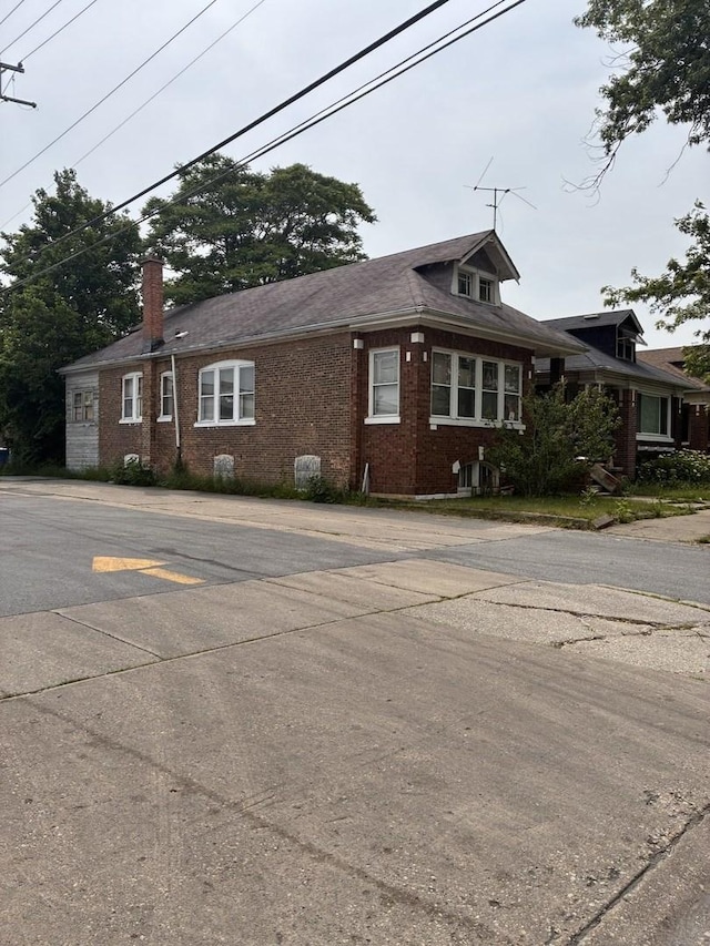 8717 S Bishop St, Chicago, IL 60620 - view of property exterior featuring brick siding and a chimney