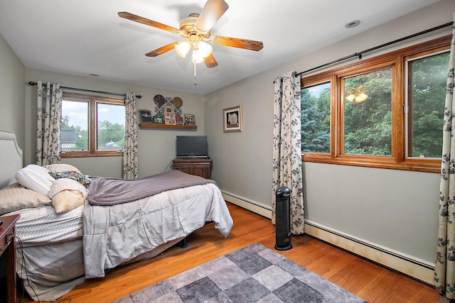 15630 Le Claire Ave, Oak Forest, IL 60452 - bedroom with a baseboard heating unit, wood finished floors, and a ceiling fan