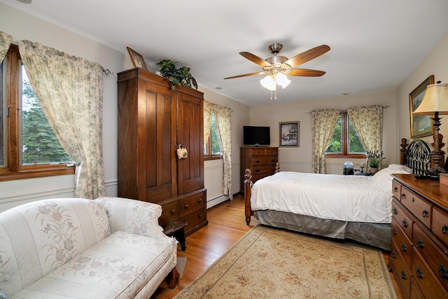 15630 Le Claire Ave, Oak Forest, IL 60452 - bedroom with a baseboard heating unit, light wood-style flooring, and ceiling fan
