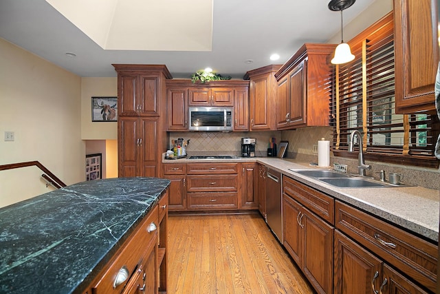15630 Le Claire Ave, Oak Forest, IL 60452 - kitchen with stainless steel appliances, light wood-style floors, tasteful backsplash, hanging light fixtures, and brown cabinets